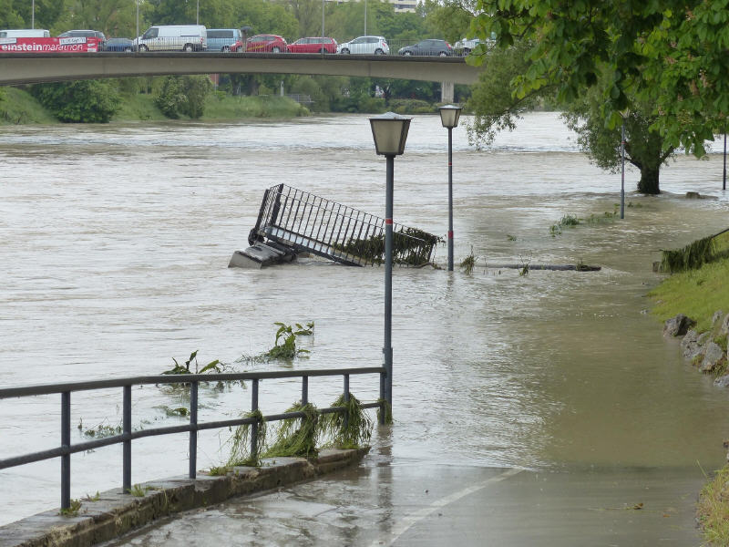 image of flooded river with cars on bridge over it
